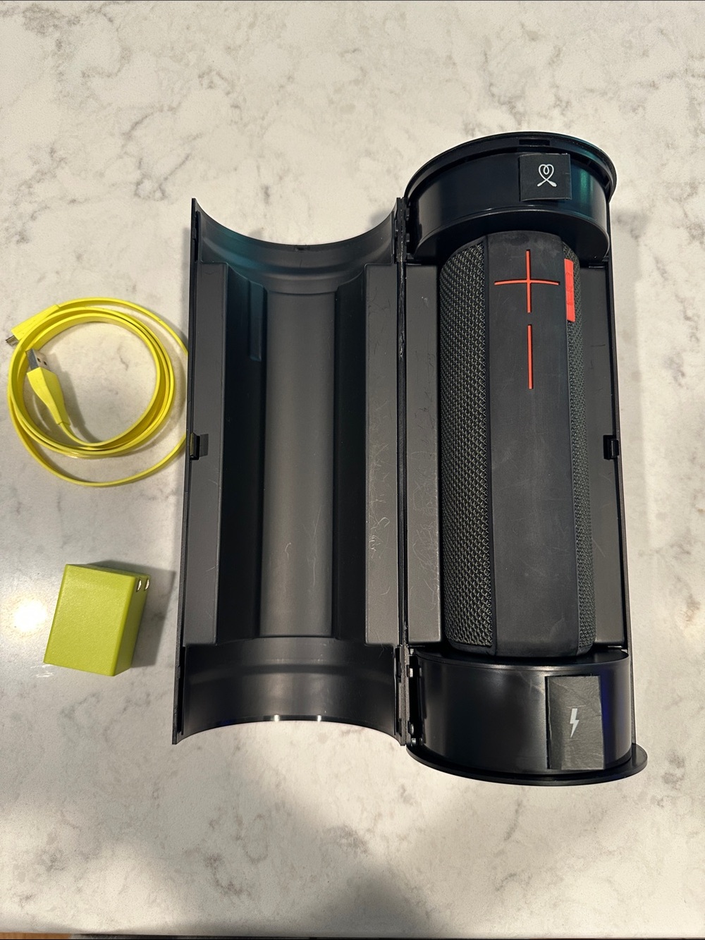 UE Black Bluetooth Speaker with Red Accent and Yellow Accessories